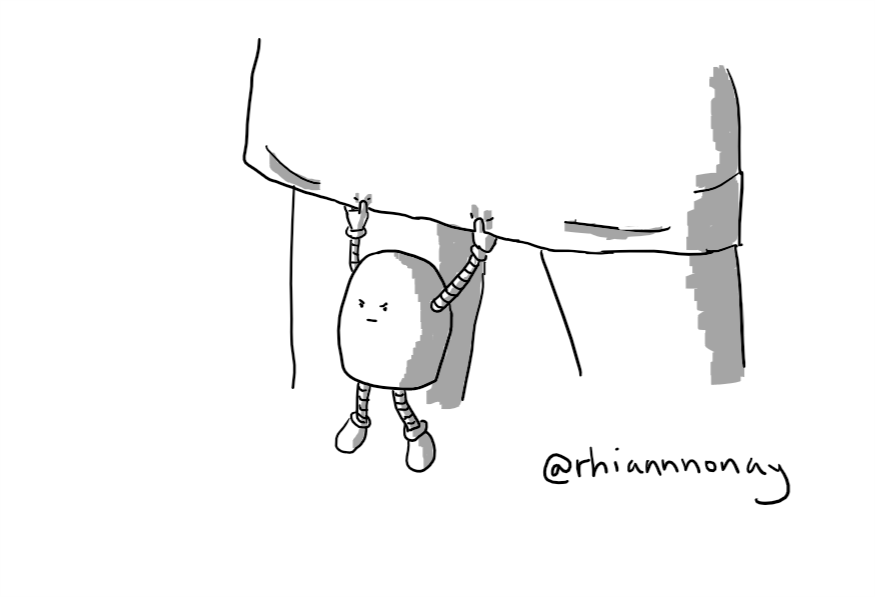 A round-topped robot hanging down from the bottom of a skirt with a grumpy expression on its face.