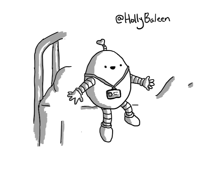 A smiling, egg-shaped robot sitting on the edge of a hospital bed. It is wearing an ID-badge on a lanyard and has an antenna with a heart-shaped tip.