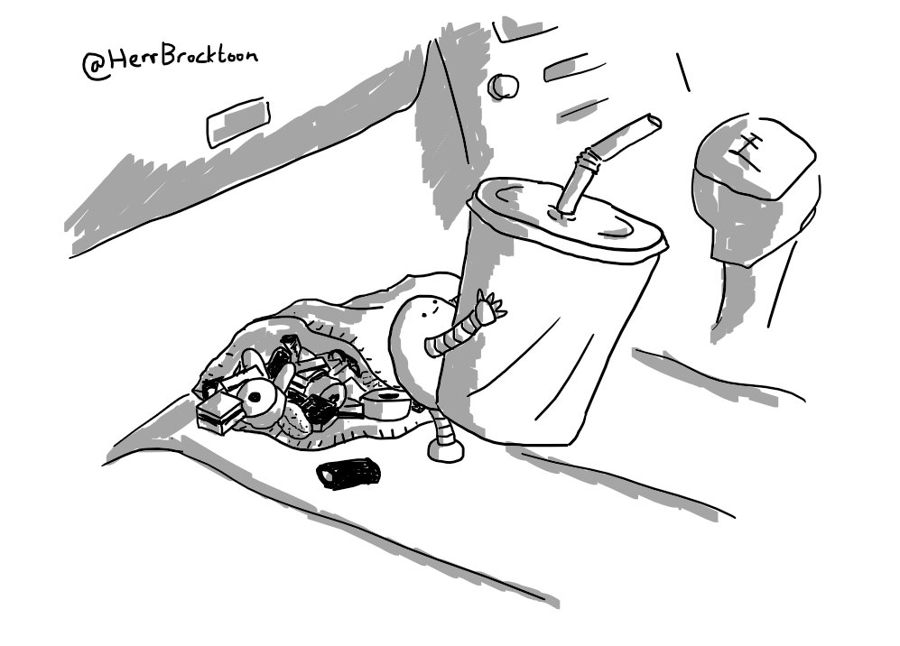 A small round robot standing on the passenger seat of a car, offering up a soft drink carton. Behind it is an open packet of liquorice all-sorts, spilling out onto the seat.