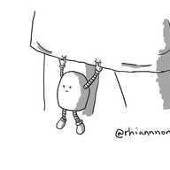 A round-topped robot hanging down from the bottom of a skirt with a grumpy expression on its face.