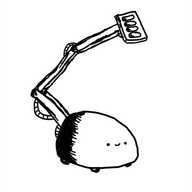 A low, dome-shaped robot on four small wheels. A hinged arm like a crane extends from its back with various wires and bolts connecting the three segments and a flat, rectangular paddle perpinducular to the arm at the end, on the front of which are four soft, rounded pads. The robot's face is at the front of its base unit and it looks very happy.