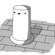 A robot in the form of a tapering cylinder with a smiling face near its top. It's set in a flanged base atop a brickwork surface.